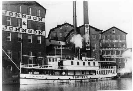 During the Delaware and Raritan Canal’s years of operation, the harbor at New Brunswick was a busy hub of factories, chandleries and shipyards. The pharmaceutical, medical device and consumer products company Johnson & Johnson had its factory adjacent to the canal. Johnson & Johnson also owned its own fleet of boats through a subsidiary company which operated as the “Middlesex Transportation Company.” Having its own steamboats allowed the company to ensure that it could quickly and reliably transport their products to the docks in New York City. This circa 1902 photograph shows the Trenton loading freight at the factory, which advertised its medical products on the building’s exterior walls. The Trenton was constructed in 1859 in Wilmington, Delaware, and operated on the Delaware River and the Delaware and Raritan Canal for 56 years. 